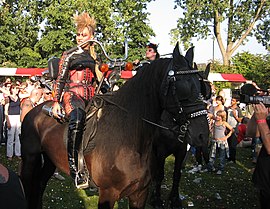 Visiting a popconcert in leather and Mohawk hairstyle on a horse with motor steering stem Horsebike Westerpop 2007.jpg