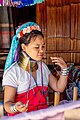 Karen tribal woman in traditional clothes doing handiwork