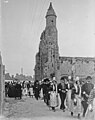 La fête des Cormorans à Penmarc'h le 5 août 1923 : Bretons et Bretonnes défilant devant l'église alors ruinée de Kérity.