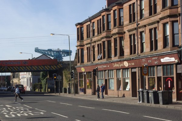 Kilbowie Road in Clydebank, featuring Clydebank railway station, with the skyline dominated by the Titan Crane.