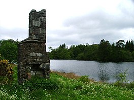 A ruin next to a body of water