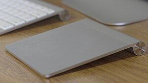 A picture of the Magic Trackpad next to the Ap...