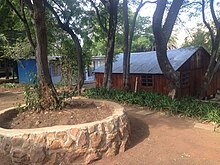 Inside Nkosi's Haven Village. Pictured in the background is one of 17 cottages used to house resident mothers, their children, and orphans. Nkosi's Haven Village.jpg