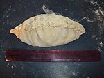 An uncooked pasty, crimped along the top