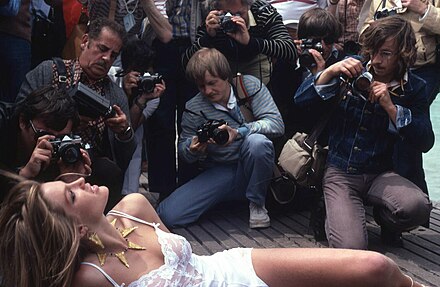 Photographers crowd around a starlet at the Cannes Film Festival.