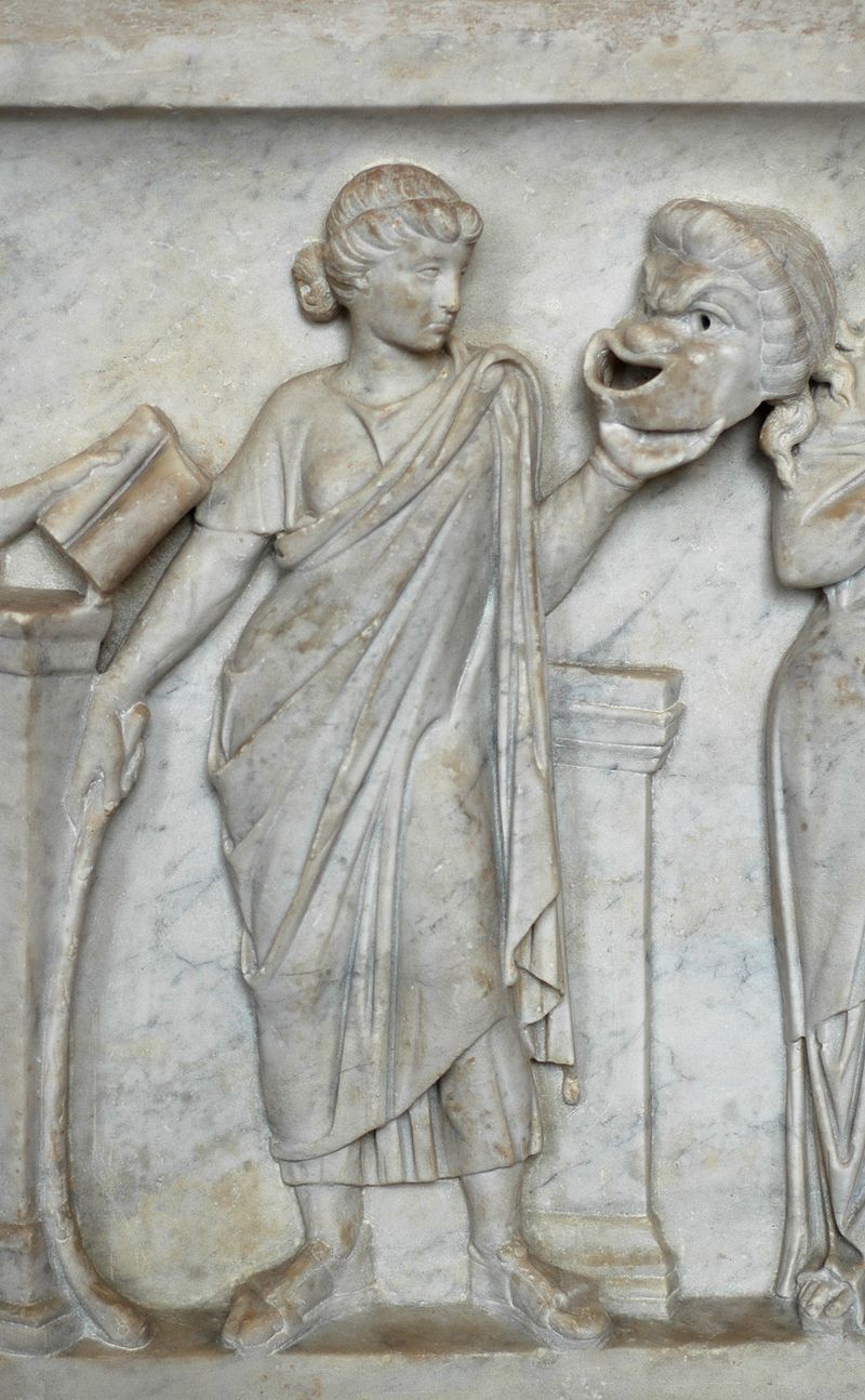 Thalia, muse of comedy, holding a comic mask. Detail from th 800px-Thalia_sarcophagus_Louvre_Ma475