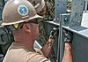 U.S. Navy Builder 2nd Class Drake Van Blarcom, left, and Steelworker 1st Class Antonio Chavezplata, both assigned to Construction Battalion Maintenance Unit 303, bolt together a metal structure during 130402-N-WX059-134.jpg