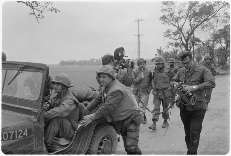 File:Vietnam. Walter Cronkite and a CBS Camera crew use a jeep for a dolly during an interview with the commanding officer... - NARA - 532454.tif