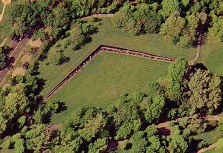 An aerial photograph of "The Wall" taken on April 26, 2002, by the United States Geological Survey. The dots visible along the length of the angled wall are visitors. For a satellite view of the Wall in relation to other monuments, see Constitution Gardens.