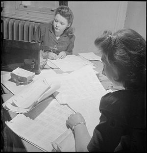 Members of staff at the Wartime Social Survey collate information in the coding room. Information from interviewers arrives in the form of ringed answers to questions on a questionnaire, and, here in the coding room, these answers are all given a code number (1944) Wartime Social Survey- Information Gathering in Wartime Britain, UK, 1944 D18858.jpg