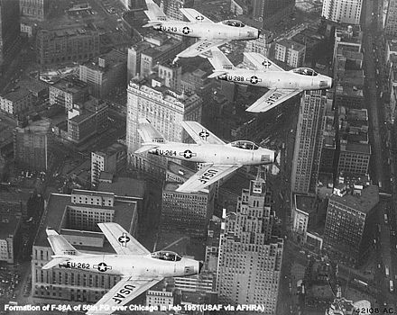 56th Fighter Group F-86A Sabres of the 62d FS flying in formation over Chicago, 1955.