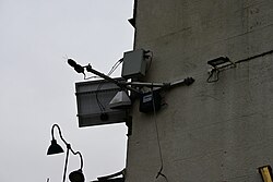 A construction noise measurement device attached to the wall of 'The Whittington and Cat' adjacent to the site entrance of the A63 Castle Street Improvement Scheme in Kingston upon Hull.