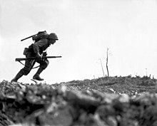 PFC Paul E. Ison, L/3/5, sprints across "Death Valley" while under heavy fire during the battle of Okinawa. A Marine dashes through Japanese machine gun fire while crossing a draw, called Death Valley by the men fighting there HD-SN-99-02888.jpg