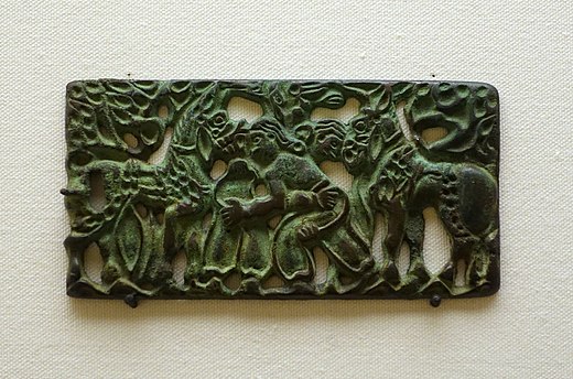 An ancient Ordos culture belt plaque, depicting two dismounted horsemen, engaged in a wrestling match, circa 2nd century BC