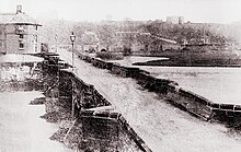 An early photograph of the 36-arch medieval Burton bridge. The bridge was an important crossing point and was the site of battles in 1322 and 1643. It was demolished and replaced in 1863.