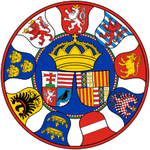 Matthias's great coat-of-arms. In the middle are personal coat of arms of Matthias Corvinus (Quartered: 1. Hungary's two-barred cross, 2. Arpad dynasty, 3. Bohemia, and 4. Hunyadi family) and that of his wife Beatrice of Naples (Quartered: 1. and 4. Arpad dynasty - France ancient - Jerusalem Impaled; 2. and 3. Aragon), above them a royal crown. On the outer edge there are coat of arms of various lands, beginning from the top clockwise they are: Bohemia, Luxemburg, Lower Lusatia, Moravia, Austria, Galicia-Volhynia, Silesia, Dalmatia-Croatia, Beszterce county Coa Hungary Country History Mathias Corvinus (1458-1490) big.svg