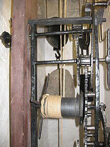 The striking train from the side. Fly arbor at the top, then the flail arbor, and the great wheel and winding barrel at the bottom. Half of the count wheel is visible on the bottom right. Cotehele clock 04.jpg