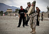 An Afghan soldier playing cricket. Afghan refugees who lived in Pakistan and India brought the sport back to Afghanistan, and it is now one of the most popular sports in the country. Cricket in Kunar Province.jpg