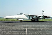 Jet aircraft with pointed nose parked on ramp.