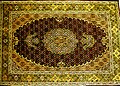 A Tabriz carpet with a fish design medallion