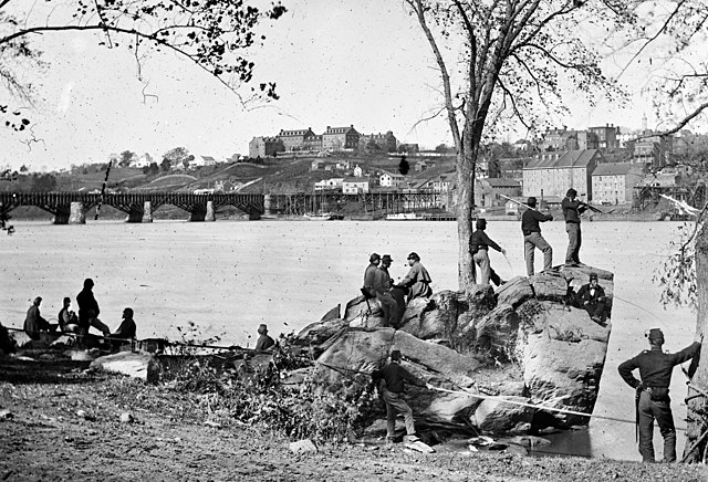 Union Army soldiers on Theodore Roosevelt Island with the Potomac River and the university visible in the background in 1861 at the beginning of the A