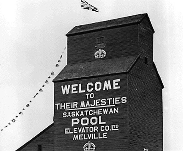 Grain elevator in Melville decorated for the visit of King George VI and Queen Elizabeth in May, 1939.