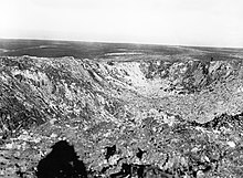 The crater left by the mine fired beneath Hawthorn Ridge Redoubt (IWM Q 1527, November 1916); note shadow of photographer, left foreground Hawthorn crater Somme Nov 1916 IWM Q 1527.jpg