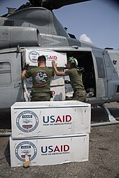 Loading relief supplies JTF 505 supplies onto heliocopter.jpg