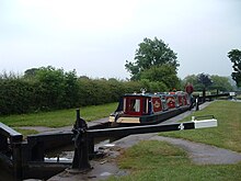 A hire boat in lock 4. The frame for the side pond paddles can be seen near the back of the boat. DSCF1010bosleylock4.JPG