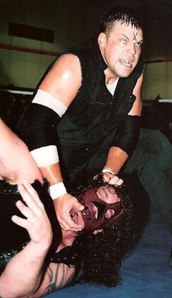 Abyss (masked) wrestling against Michael Sain