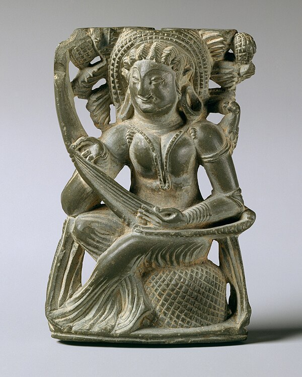 Carved decoration from a hand-mirror's handle, depicting a woman playing the vina, 6th–7th century.