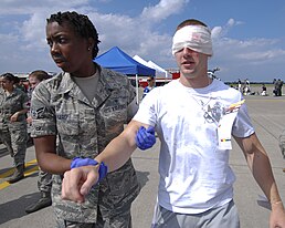 An U.S. Air Force emergency responder from the 35th Medical Group evacuates a simulated casulaty during a major accident response exercise at Misawa Air Base.