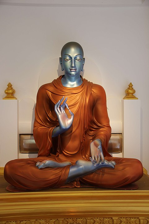A statue of the arahant Moggallana, who is identifiable by his dark (nila, i.e. blue/black) skin. He was one of the two most senior disciples of the Buddha and the foremost in psychic powers.