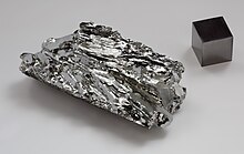 Molybdenum crystaline fragment and 1cm3 cube.jpg