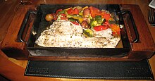 "Fish in a box", fresh fish served with Mediterranean vegetables in a Montevideo, Uruguay restaurant