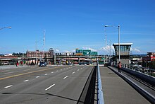 The bridge's deck after the 2011-12 renovations that removed the steel grating. Also visible are signs indicating the freeway connections. Morrison Br roadway view, looking east from lift span in 2012.jpg