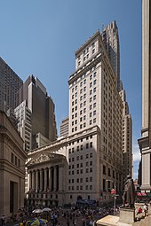 Photograph of two intersecting streets filled with pedestrians with high rise buildings in the background