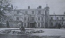 A view of Finch House from the east showing the main entrance and the statue brought from Bemerton Lodge OMHmain entrance about 1950.JPG