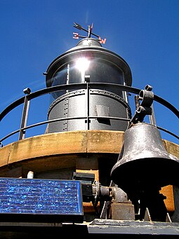 Fort Denison's lantern, bell and solar panel PLJohnson Fort Denison Light detail4 bellfront.jpg