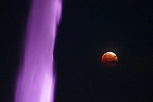 Red moon from a lunar eclipse with the fountain in the foreground