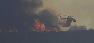 A S-64 Skycrane helicopter drops flame retardant on the fire S-64 Skycrane at La Brea Fire.jpg