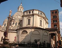 Outside view from the West, with domes, portico, column, and belltower. Santuario della Consolata Torino.JPG