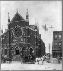 Old St. Augustine, circa 1899; view from 15th Street with two horse-drawn carriages. This photo was part of a display on the "present conditions" of African Americans for the 1900 Paris Exposition. St. Augustine Church, Washington, D.C. c. 1899.tif