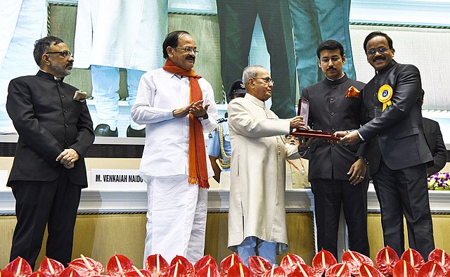 Shri Pranab Mukherjee presenting the Swarna Kamal Award for the Best Film Critic to Shri G. Dhananjayan