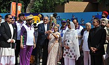 Mr. Mike Fennel, President of the CGF hands over the Baton to Sheila Dikshit, Chief Minister of Delhi at Wagah Border, Punjab The President of the Commonwealth Games Federation, Mr. Mike Fennel hands over the Queen`s Baton Delhi 2010 to the Chief Minister of Delhi, Smt. Sheila Dikshit at Wagah Border, Punjab on June 25, 2010.jpg