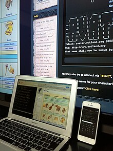 A smartphone, laptop and desktop system connected to AVATAR MUD using different clients. A player-created wiki can also be seen on two of the screens. Three different devices connected to a MUD via different Telnet Clients.JPG