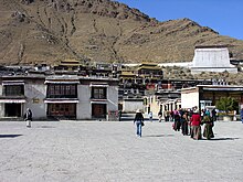 Tashilhunpo Monastery; the thangka wall seen at far right from the entrance. Tibet-6070 (2693586600).jpg