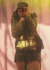 Tulisa during a concert with N-Dubz at Glastonbury Festival in June 2010 Tulisa1 (cropped).jpg