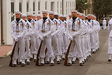 Enlisted sailors of the United States Navy in Full Dress Whites during a retirement ceremony.