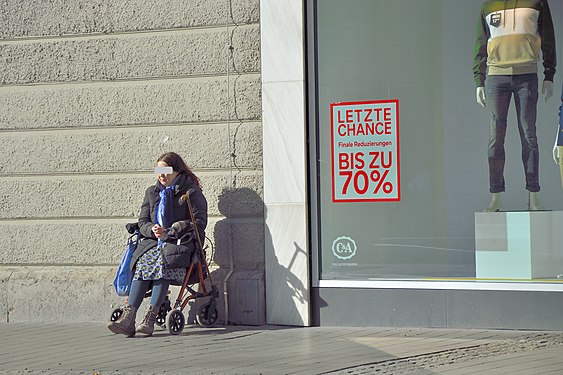 Woman sitting on rollator enjoying the first spring sun